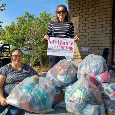 Diana & Santa with some of the beanies, jerseys & blankets donated for our 2022 woollen drive